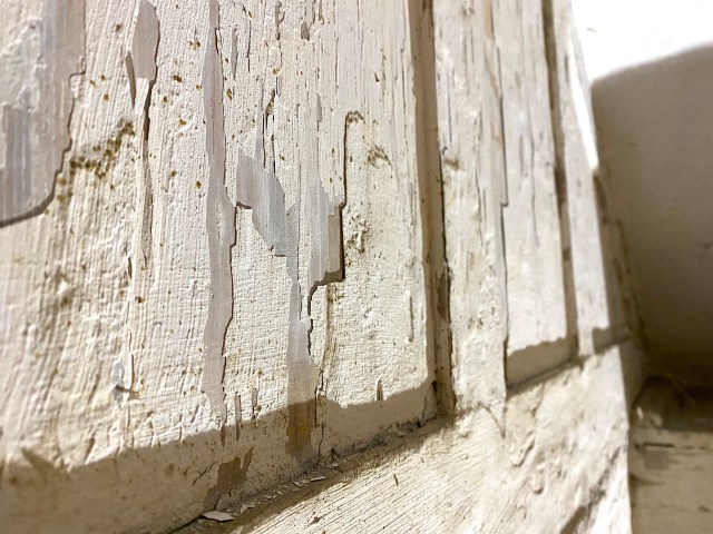peeling paint on woodwork in cellar