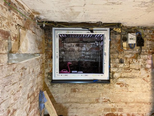 fitting a window in a cellar or basement
