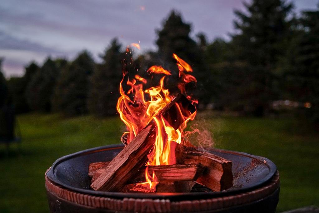 A fire pit provides warmth and comfort for an outdoor evening party