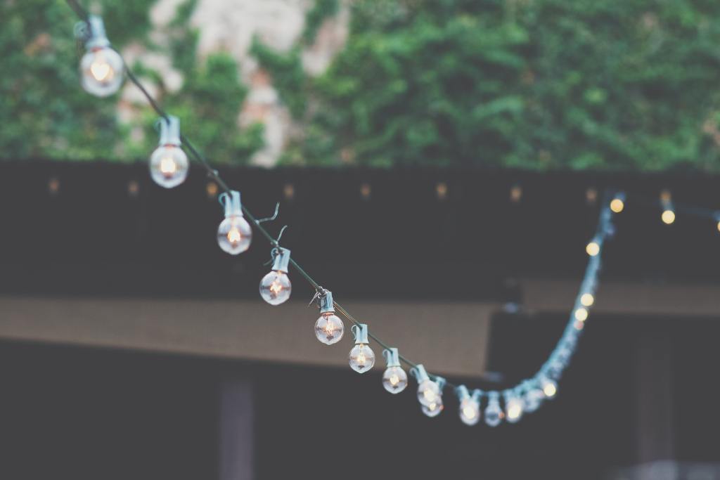 String fairy lights in your garden to create atmosphere at an outdoor party