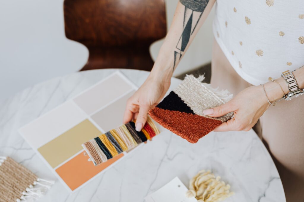 A person choosing carpet and paint samples is an important part of the home renovation process.