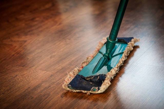 A mop on a wooden floor.