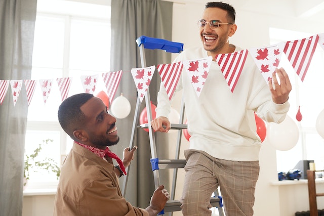 Two people smiling while decorating
